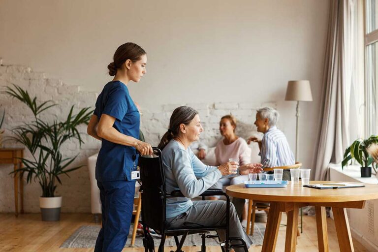 Older adult and family member reviewing daily care needs at a kitchen table.